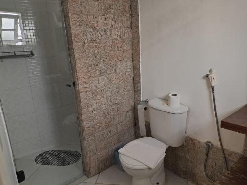 a bathroom with a toilet and a shower at Pousada D'amoras in Conservatória