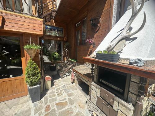 a porch of a house with potted plants on it at NIKI HOUSE in Bansko