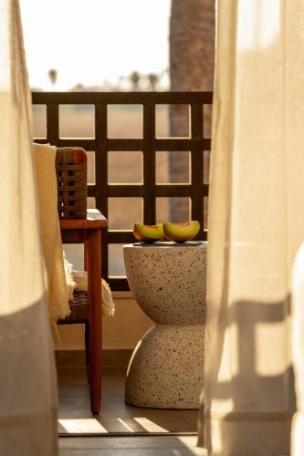 two bananas sitting on top of a pot on a balcony at The Ritual, A Wellness Retreat in Lampi