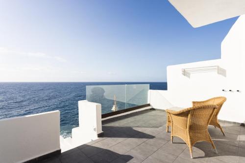 a balcony with a view of the ocean at Home2Book Serene Stay & Sea View Terrace in Arico in La Mareta