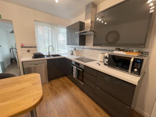 a kitchen with a sink and a microwave at Dunperrogh in St. Andrews