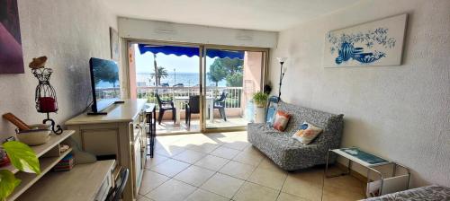 - un salon avec un canapé, une chaise et une table dans l'établissement 1 bedroom apartment - sea view, à Fréjus