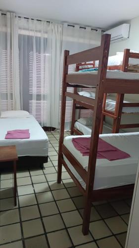 a room with two bunk beds in a room at Rô Hostel Cabo Branco in João Pessoa