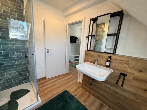 a bathroom with a sink and a shower at harmony holiday, Pension in Kerschenbach