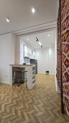 an office with a desk and a counter in a room at Tirent Apartment-Modern Bedrooms Stay Near Liqeni i Thatë in Tirana