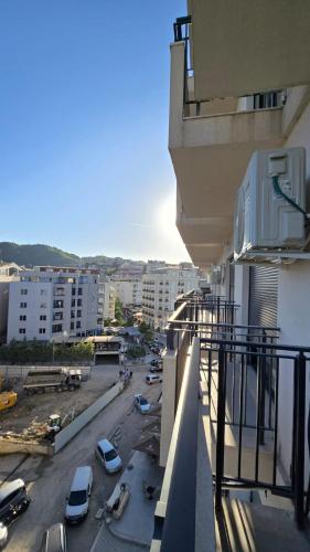 a view of a parking lot from a balcony of a building at Tirent Apartment-Modern Bedrooms Stay Near Liqeni i Thatë in Tirana
