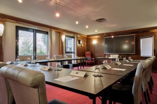 a conference room with a large table and chairs at Hotel Restaurant Crystal in Erstein