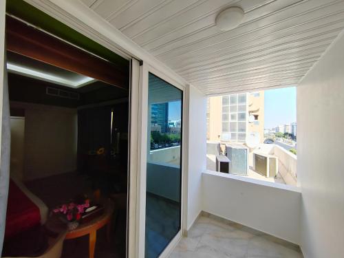 a balcony with a view of a room with a window at Le Paradise Palace Hotel Deira Dubai Al Rigga in Dubai