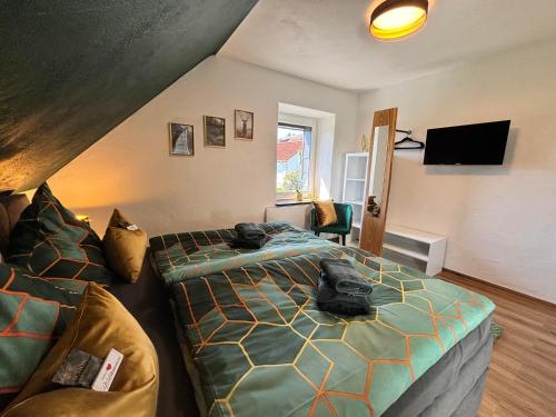 a bedroom with a bed and a couch at harmony holiday, Pension in Kerschenbach