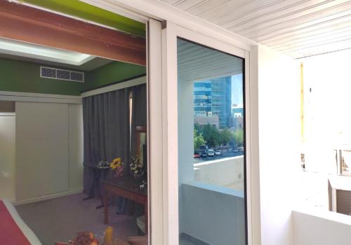 a sliding glass door to a balcony with a view of a city at Le Paradise Palace Hotel Deira Dubai Al Rigga in Dubai