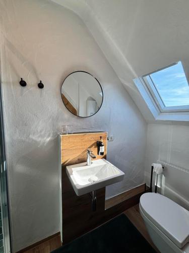 a bathroom with a sink and a mirror at harmony holiday, Pension in Kerschenbach