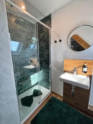 a bathroom with a shower and a sink and a mirror at harmony holiday, Pension in Kerschenbach