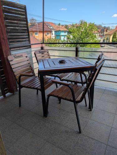 a wooden table and two chairs on a balcony at Urban Haven - Families & Groups - Free Parking in Cluj-Napoca
