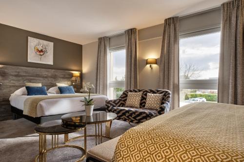a hotel room with a bed and a chair at Hotel Restaurant Crystal in Erstein