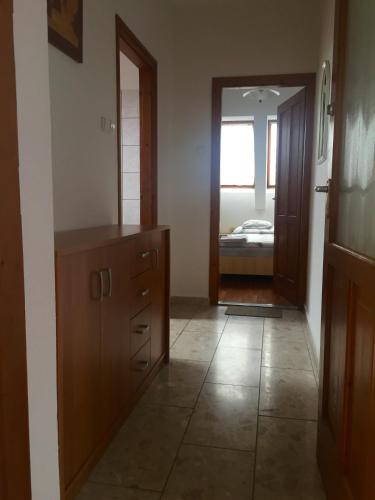 a room with a dresser and a mirror and a bedroom at Mol-Ker-Vill Apartment in Lenti