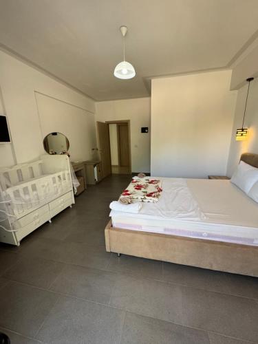 a bedroom with two white beds in a room at Hotel Irini in Sarandë