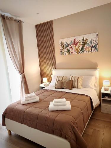a bedroom with a large bed with two towels on it at La casa di Zucchero in Monreale
