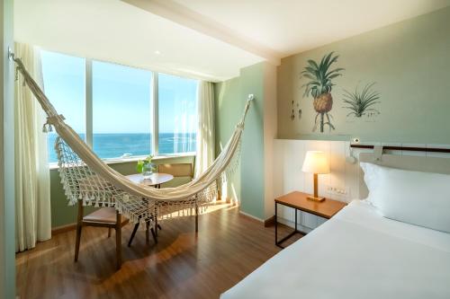 a room with a hammock in a hotel room at Grand Mercure Rio de Janeiro Copacabana in Rio de Janeiro