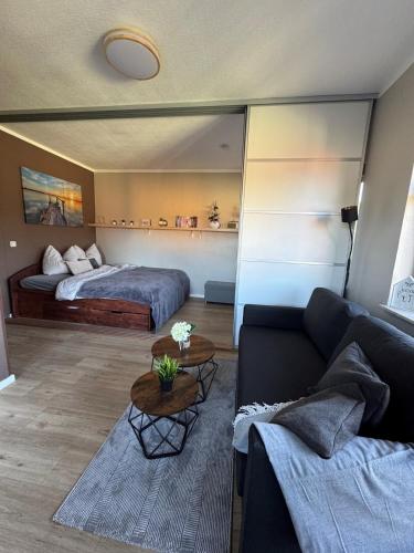 a living room with a couch and a bed at Happy Place am Plauer See in Zislow