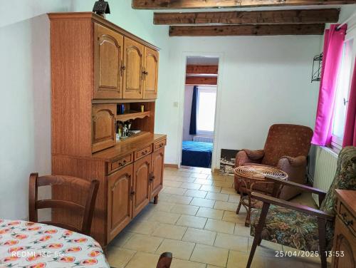 a kitchen with a large wooden cabinet in a room at Appartement charmant à Le Vigan avec terrasse in Le Vigan