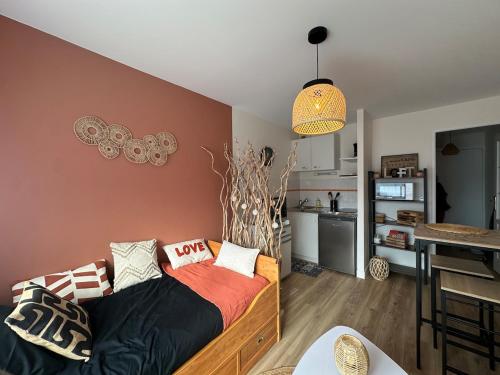 un salon avec un canapé et une cuisine dans l'établissement Le Petit Pillon - studio avec parking, à Vannes