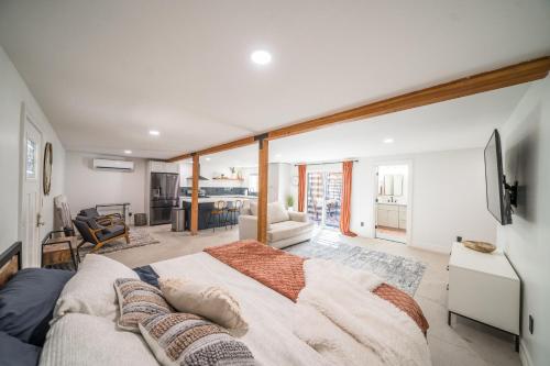 a bedroom with a large bed and a living room at Studio 1 Ashbrook in Mesa
