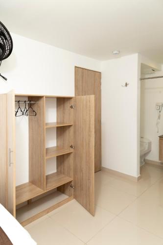 a bathroom with wooden cabinets and a toilet at Bajo la luna hotel in Medellín