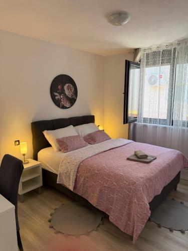 a bedroom with a large bed and a window at Villa Tome in Vir