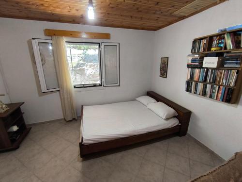 a small bedroom with a bed and a window at Cuckoo's view in Análipsis