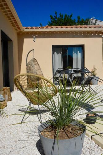 a patio with two chairs and a table at Le Bonheur à Ventoux in Saint-Pierre-de-Vassols