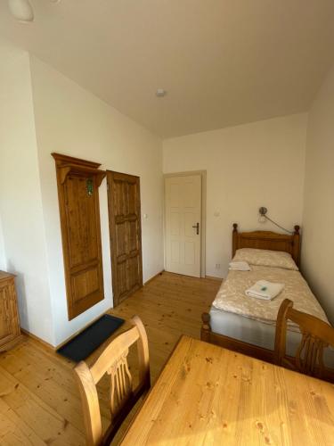 a bedroom with a bed and a wooden floor at Zámeček Waldsteinovo Zátiší in Svatoslav