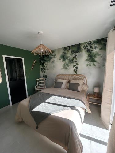 a bedroom with a large bed with green walls at Le Bonheur à Ventoux in Saint-Pierre-de-Vassols
