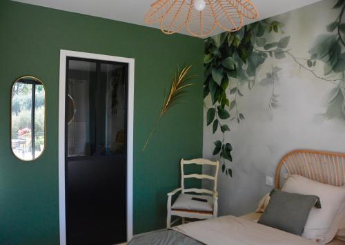 a bedroom with a green wall with a bed and a ladder at Le Bonheur à Ventoux in Saint-Pierre-de-Vassols