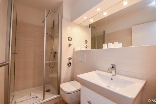 a bathroom with a shower and a sink and a toilet at Haus "Nautilus" Appartement NAU11 in Duhnen