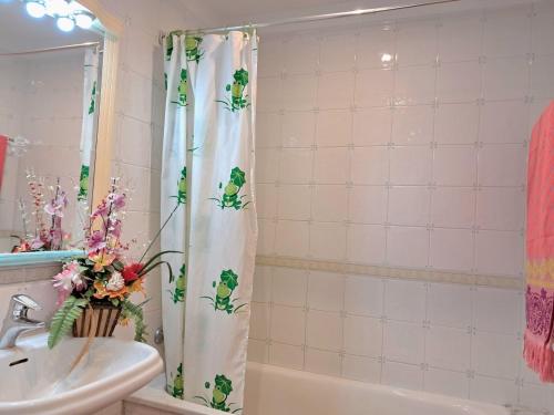 a bathroom with a shower curtain with frogs on it at Villa ALVAMAR in Blanes