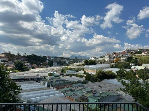 arial view of a city with buildings and clouds at Umee Stayin Đà Lạt in Da Thanh