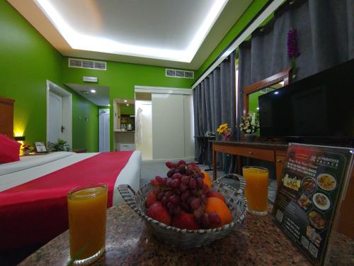 a hotel room with a bowl of fruit on a table at Le Paradise Palace Hotel Deira Dubai Al Rigga in Dubai