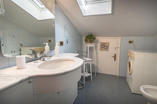 a bathroom with a sink and a mirror at La Mansarda Dell'Ulivo in Santa Maria degli Angeli