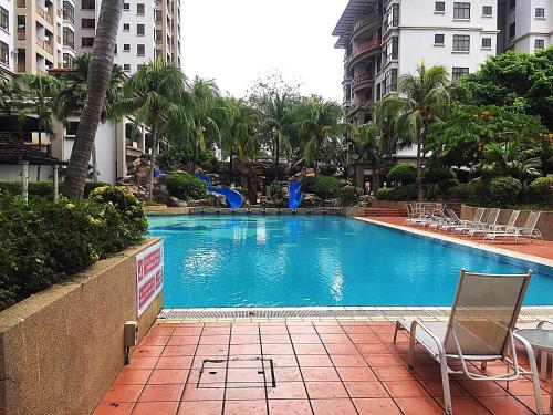 a swimming pool with chairs and trees and buildings at Seanest Residence 贤巢民宿 14 "Owned by Amadel Residence" in Melaka