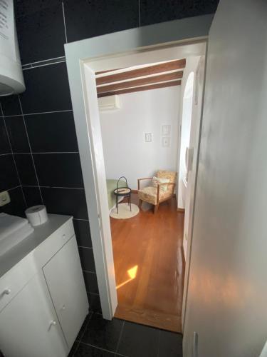 a bathroom with a door open to a room at Dosud House Studios in Split
