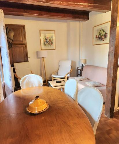 a living room with a wooden table and chairs at Gîte Le Barry in Le Caylar