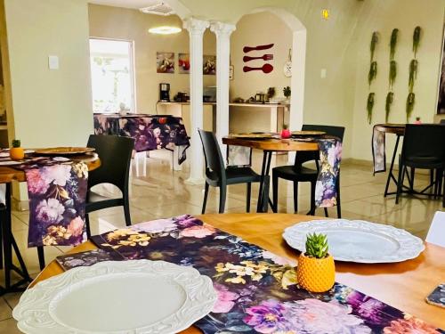 a dining room with a table with plates on it at Wölfe Krantz Accommodation in Nelspruit