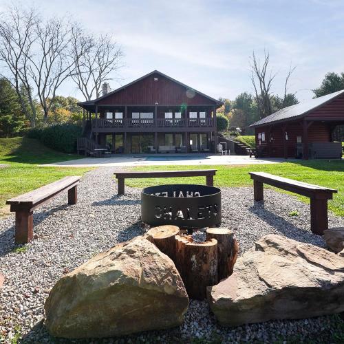 a park with benches and rocks in front of a building at Grande Butte Lodge - by The Chalets in Laurelville