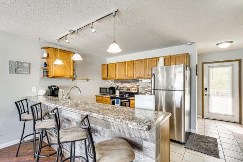 a kitchen with a counter and a refrigerator at Lakefront Osage Beach Condo with Balcony and Pool in Osage Beach
