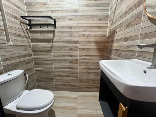 a bathroom with a toilet and a sink at Capital O 91152 Jerot Dusun Campsite in Kampong Bukit Tumboh