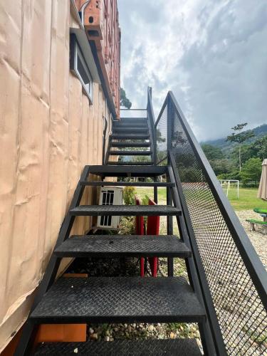 a set of stairs leading up to a building at Capital O 91152 Jerot Dusun Campsite in Kampong Bukit Tumboh