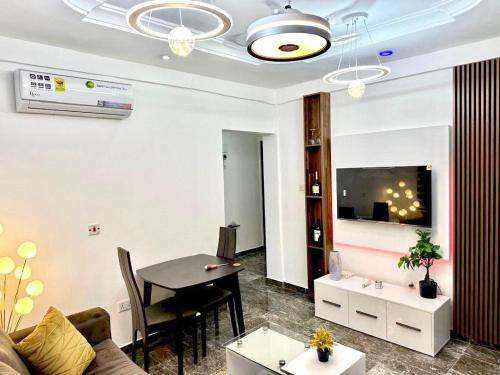 a living room with a table and a dining room at Kan's Krib in Accra