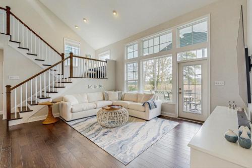 a living room with a couch and a staircase at Marlin Chase --- 30347 Bermuda Dr in Ocean View