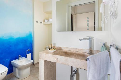 a bathroom with a sink and a toilet at La casa del pescatore in Cala Gonone