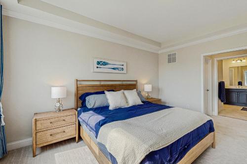 a bedroom with a bed with a blue comforter at Marlin Chase --- 30347 Bermuda Dr in Ocean View